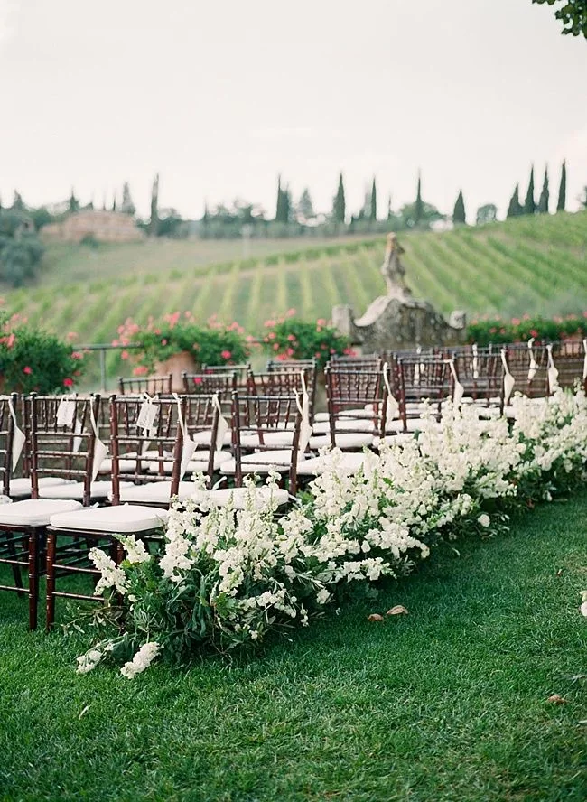 Outdoor wedding ceremony with a scenic vineyard backdrop