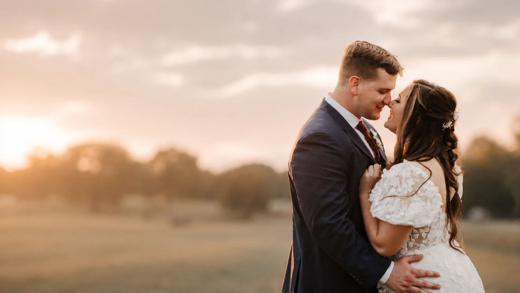 Newlywed couple embracing at golden hour with open space for Southern Flair wedding consulting message
